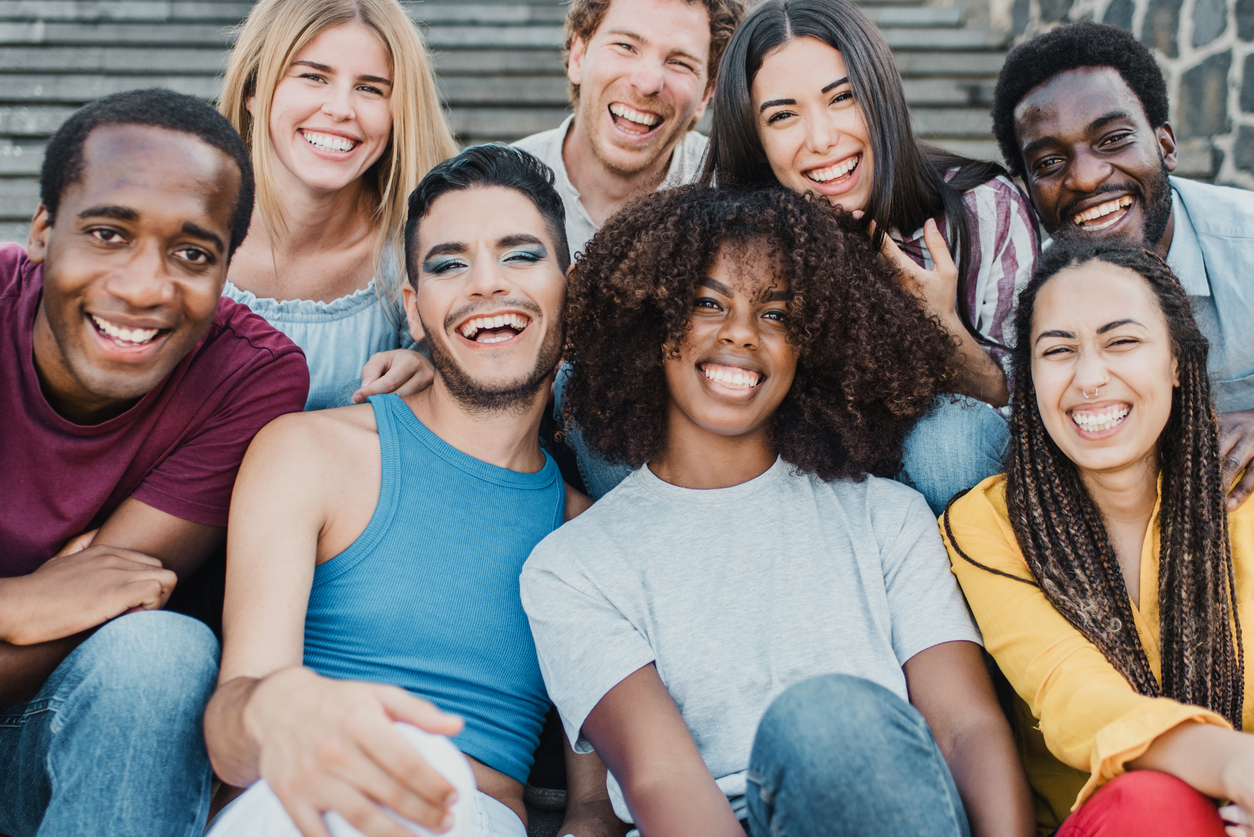 Young group of people smiling on camera having fun outdoor in the city - Focus on african girl face