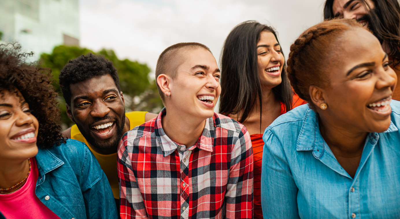 Young multi ethnic friends having fun together hanging out in the city - Friendship and diversity concept